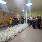 Director Victor Zama with volunteers after packing 60 food packages for the elderly.