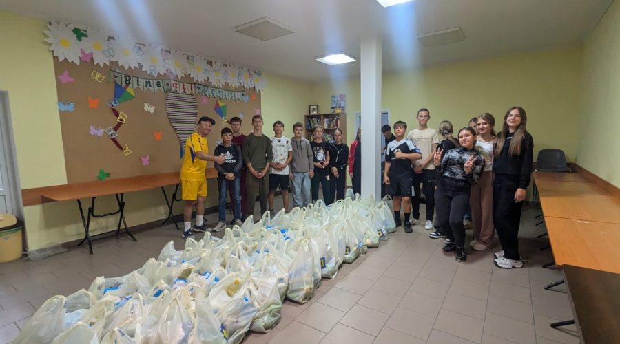 Director Victor Zama with volunteers after packing 60 food packages for the elderly.