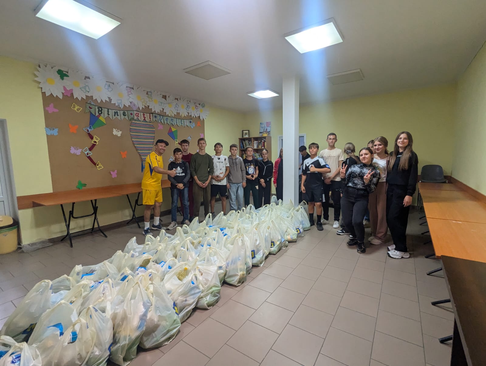 Director Victor Zama with volunteers after packing 60 food packages for the elderly.