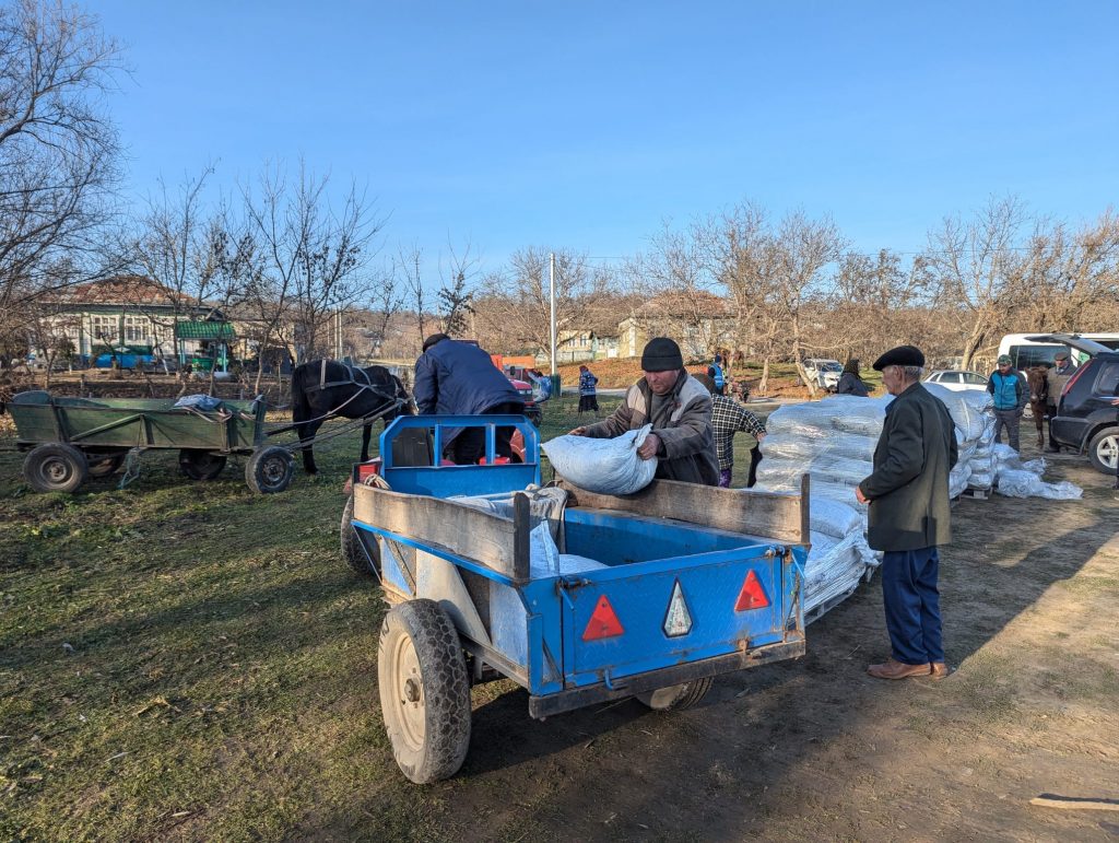 A man loading his trailer with coal.