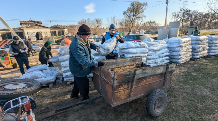 Two men loading a trailer with coal.