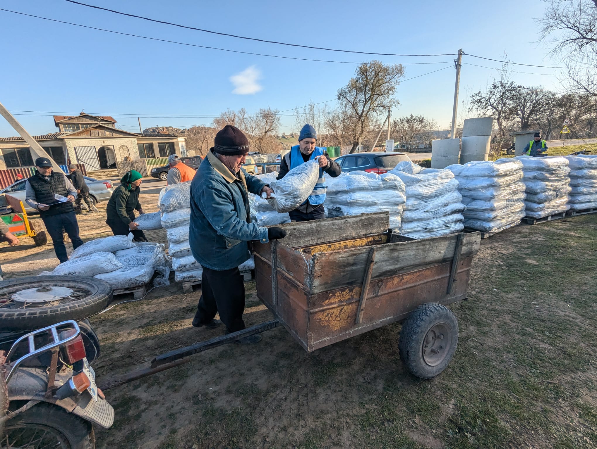 Two men loading a trailer with coal.