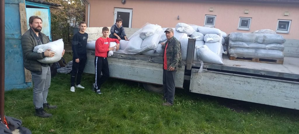 Victor and volunteers unloading coal from the delivery truck