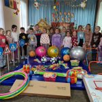 Kindergarten children posing with their new toys.