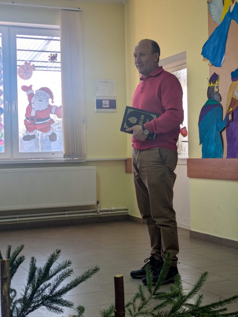 Victor Zama giving a speech with a bible in his hand.