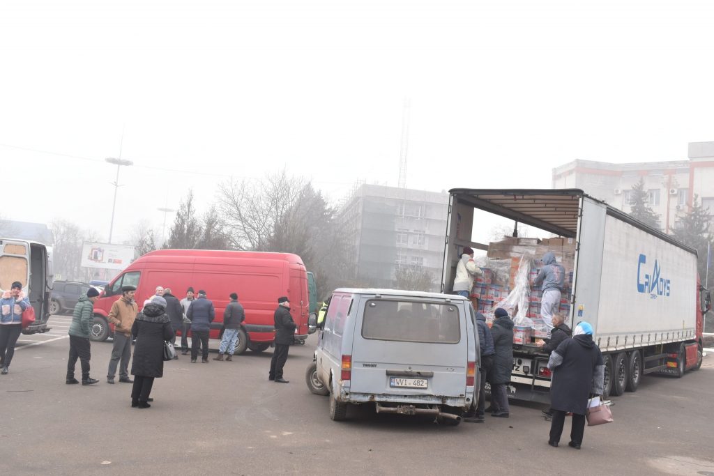 Men preparing to unload gifts from a semi-truck.