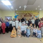 Children, parents, the priest, and AO Neemia staff posing for a picture.