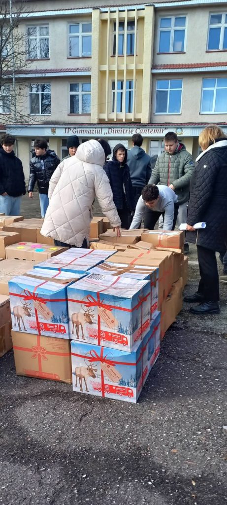 Teenagers stacking boxes with gifts.