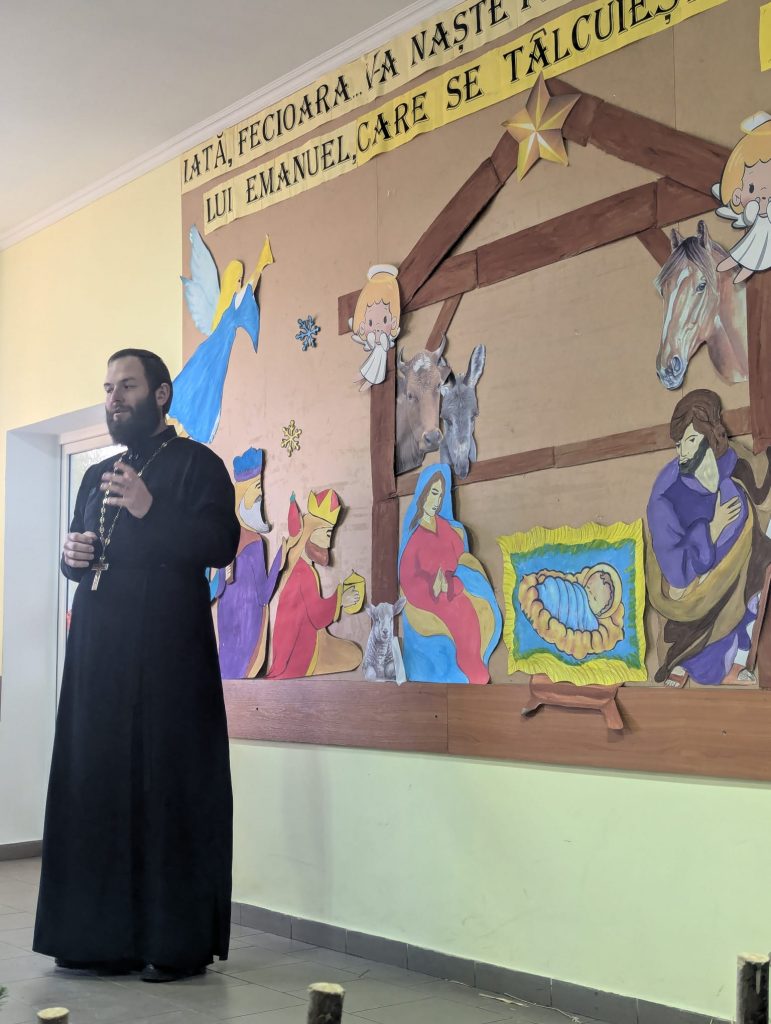 The village priest giving a speech.