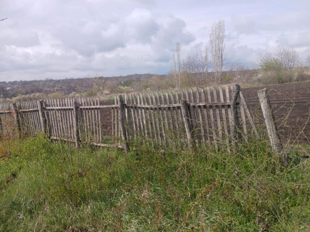 The old wooden fence. Broken, not straight, ugly