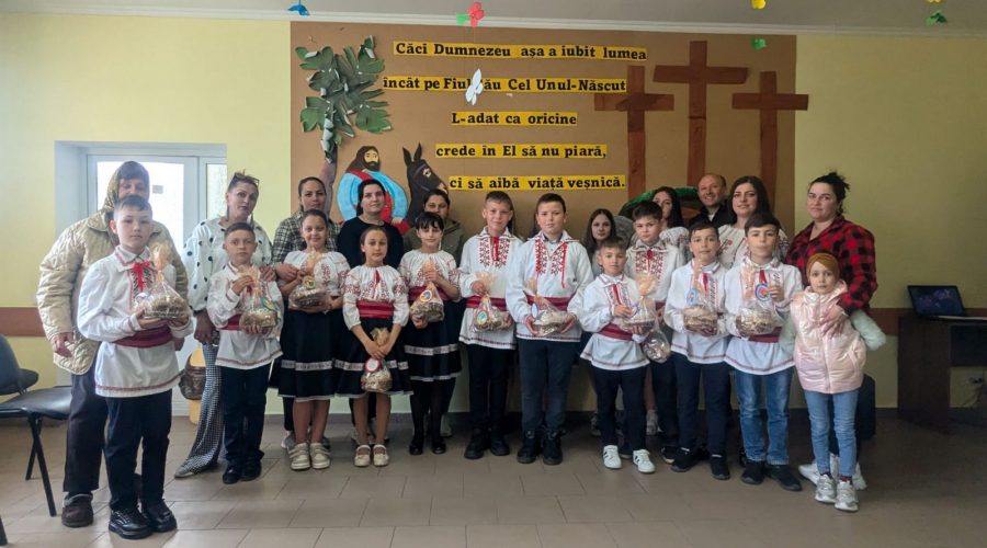 The children at the community center posing with their parents, Angela and Victor.