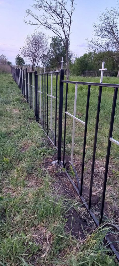 The new, beautiful, black fence with crosses