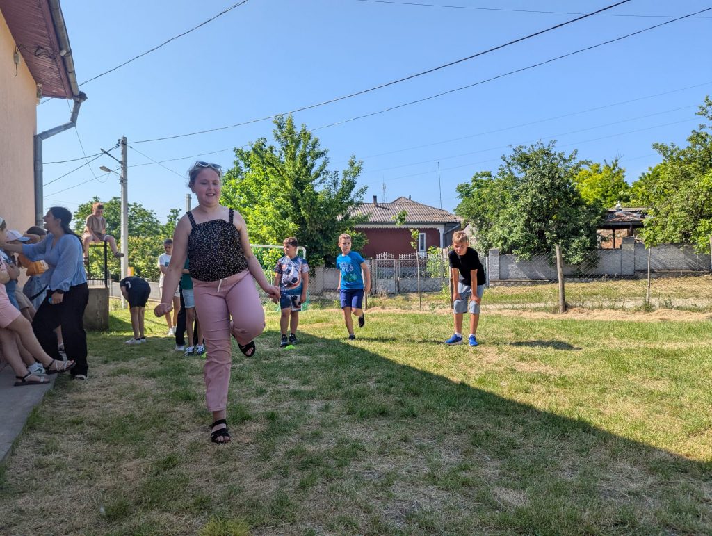 A child hopping on one foot during a game.