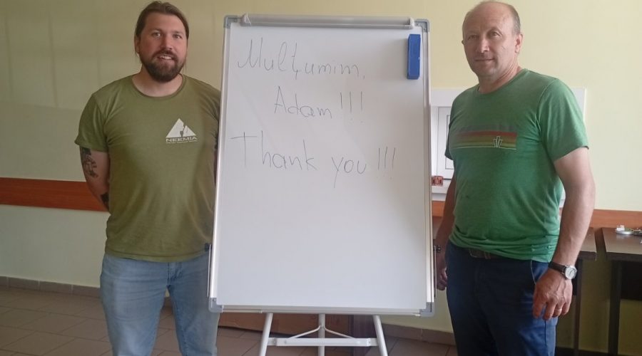 Victor and Adam standing in front of the whiteboard. "Mulțumesc Adam!!! Thank you!!!" is written on it.