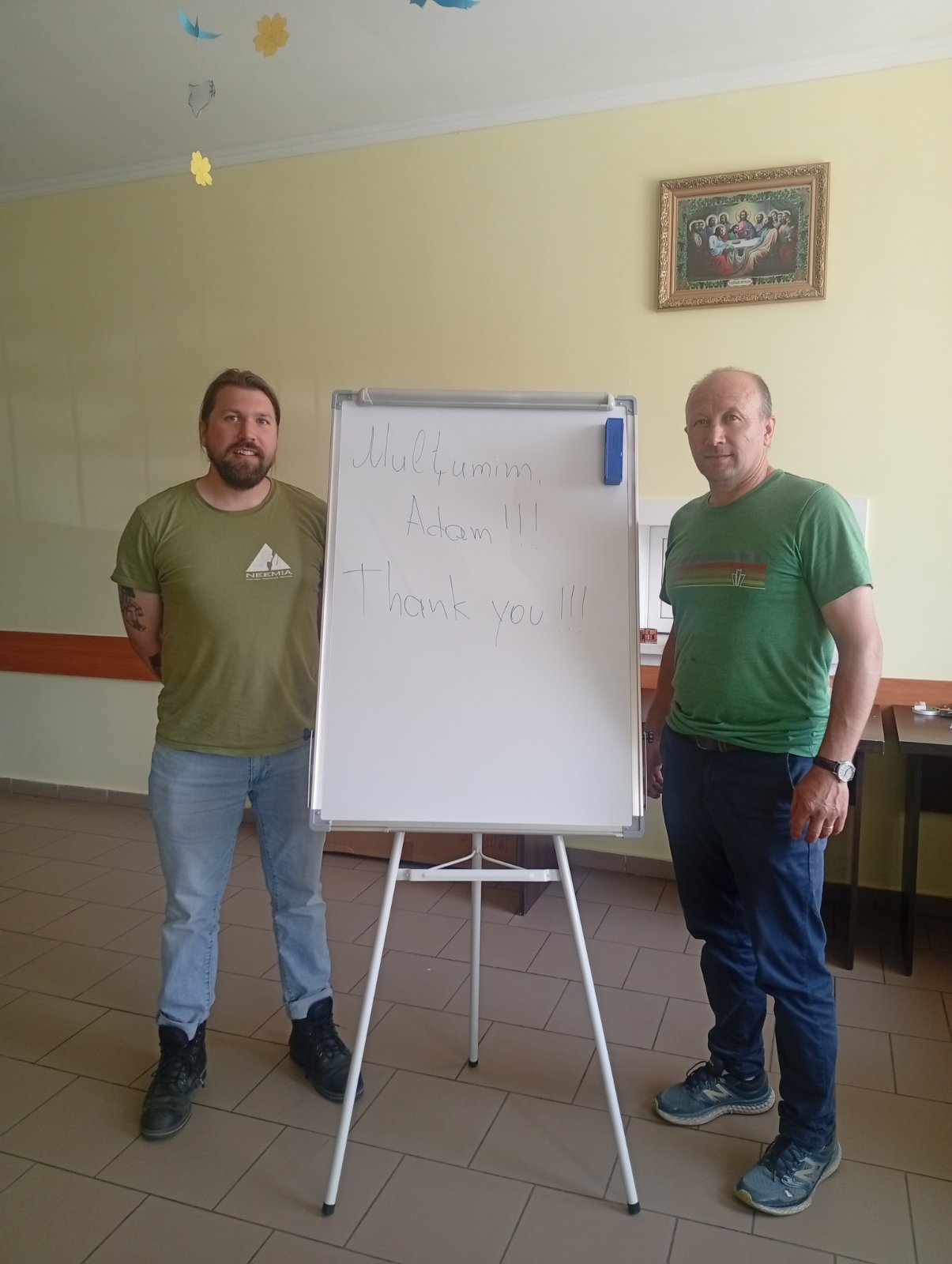 Victor and Adam standing in front of the whiteboard. "Mulțumesc Adam!!! Thank you!!!" is written on it.