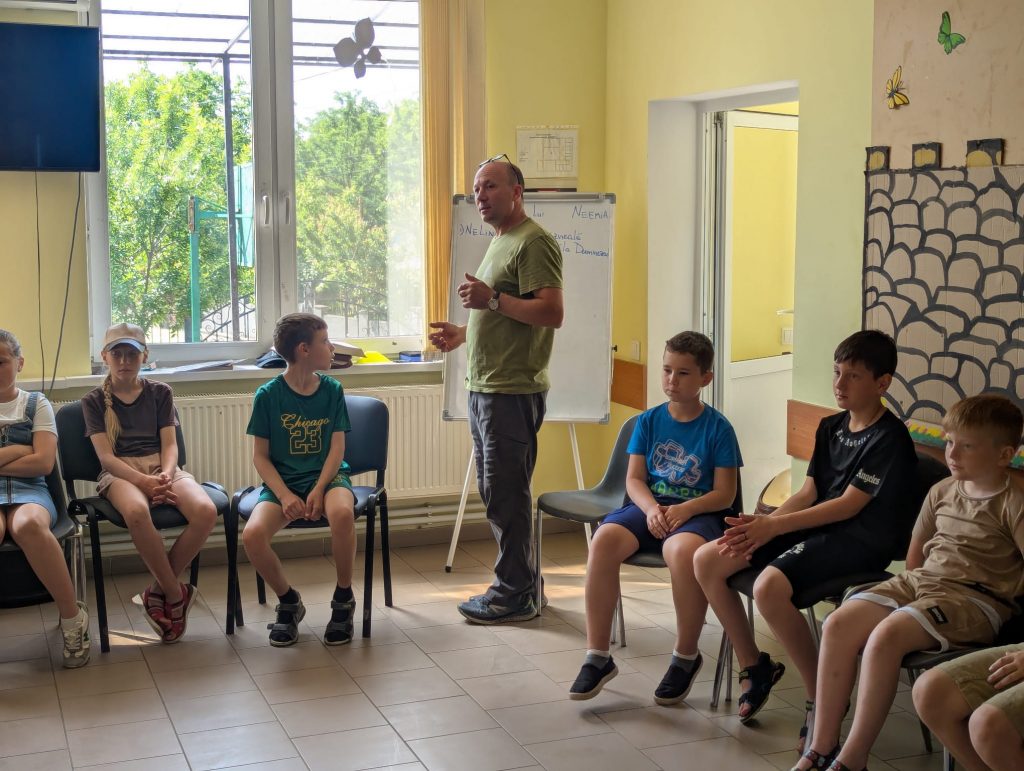 Mr. Victor telling bible stories to the children.