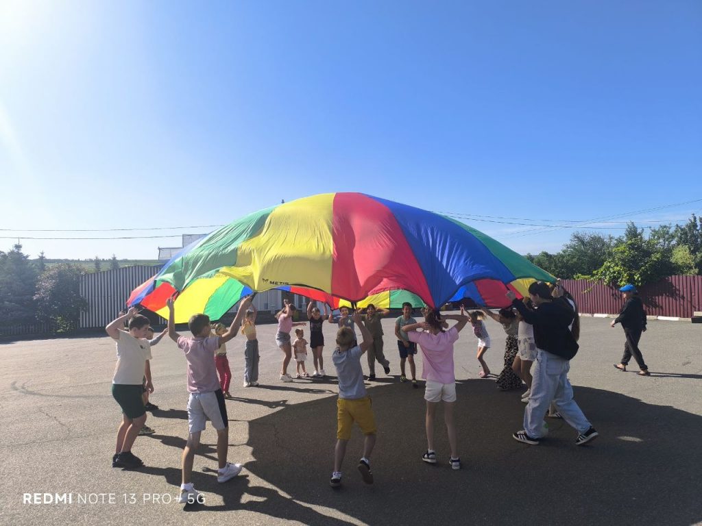 Kids playing with a parachute