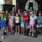 Kids posing with their crafts with Victor.